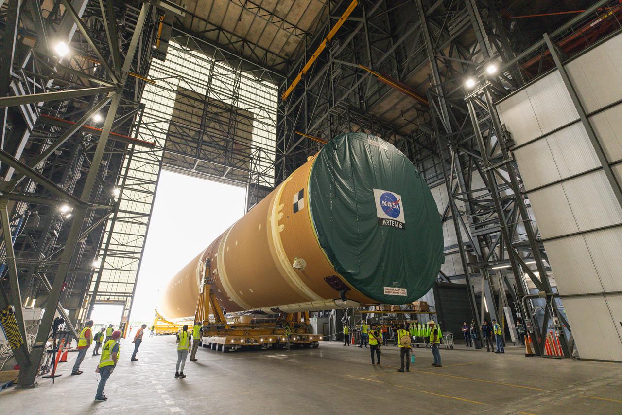 After completing its journey from NASA’s Michoud Assembly Facility in New Orleans aboard the Pegasus barge, teams with Exploration Ground Systems (EGS) transport the agency’s powerful SLS (Space Launch System) core stage into the transfer aisle inside Kennedy Space Center’s Vehicle Assembly Building in Florida on Wednesday, July 24, 2024. In the coming months, SLS will be prepared for integration atop the mobile launcher ahead of the Artemis II launch. 