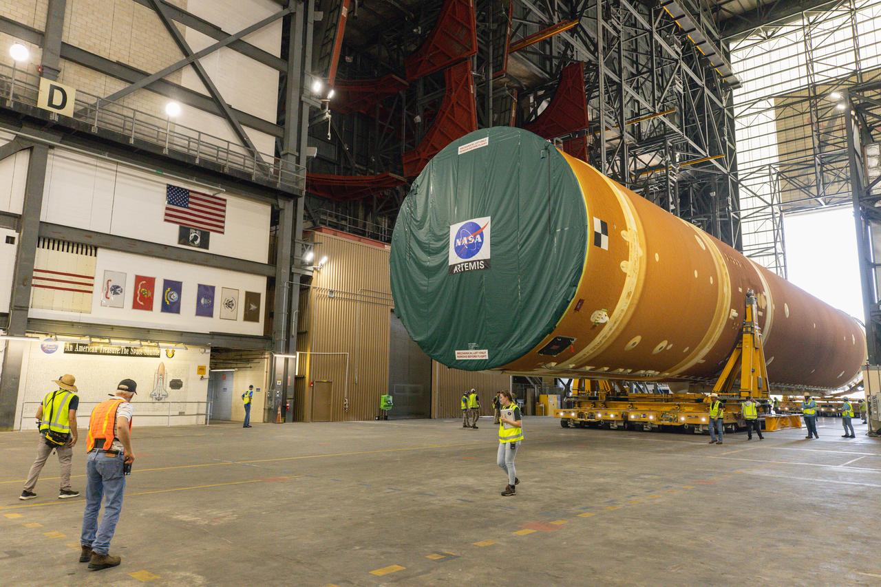 After completing its journey from NASA’s Michoud Assembly Facility in New Orleans aboard the Pegasus barge, teams with Exploration Ground Systems (EGS) transport the agency’s powerful SLS (Space Launch System) core stage into the transfer aisle inside Kennedy Space Center’s Vehicle Assembly Building in Florida on Wednesday, July 24, 2024. In the coming months, SLS will be prepared for integration atop the mobile launcher ahead of the Artemis II launch.