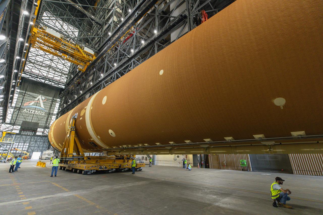 After completing its journey from NASA’s Michoud Assembly Facility in New Orleans aboard the Pegasus barge, teams with Exploration Ground Systems (EGS) transport the agency’s powerful SLS (Space Launch System) core stage into the transfer aisle inside NASA’s Kennedy Space Center’s Vehicle Assembly Building in Florida on Wednesday, July 24, 2024. In the coming months, SLS will be prepared for integration atop the mobile launcher ahead of the Artemis II launch.