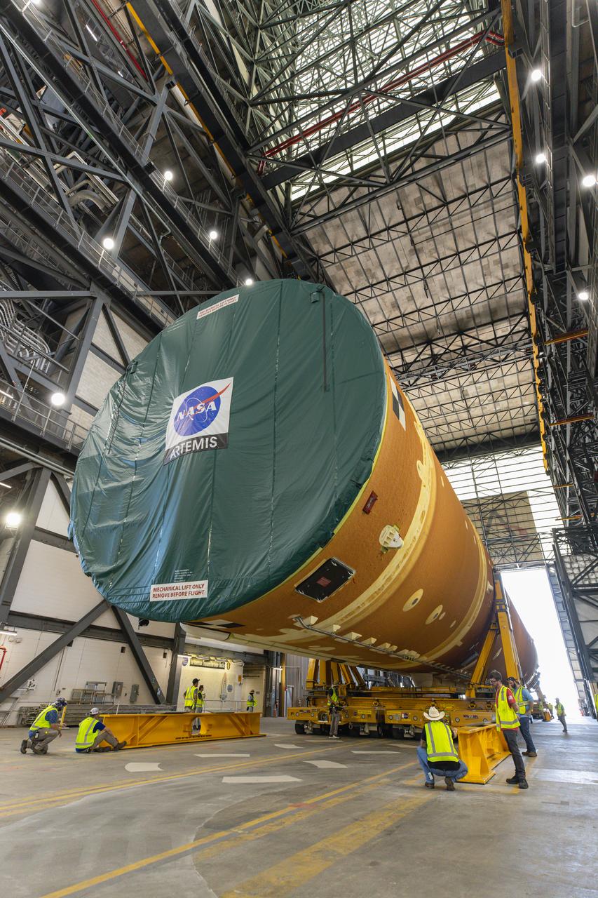 After completing its journey from NASA’s Michoud Assembly Facility in New Orleans aboard the Pegasus barge, teams with Exploration Ground Systems (EGS) transport the agency’s powerful SLS (Space Launch System) core stage into the transfer aisle inside Kennedy Space Center’s Vehicle Assembly Building in Florida on Wednesday, July 24, 2024. In the coming months, SLS will be prepared for integration atop the mobile launcher ahead of the Artemis II launch. 