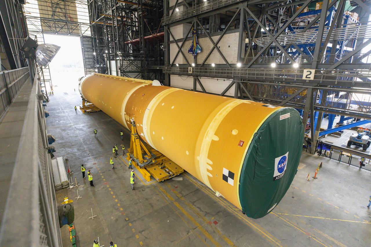 After completing its journey from NASA’s Michoud Assembly Facility in New Orleans aboard the Pegasus barge, teams with Exploration Ground Systems (EGS) transport the agency’s powerful SLS (Space Launch System) core stage into the transfer aisle inside Kennedy Space Center’s Vehicle Assembly Building in Florida on Wednesday, July 24, 2024. In the coming months, SLS will be prepared for integration atop the mobile launcher ahead of the Artemis II launch. 