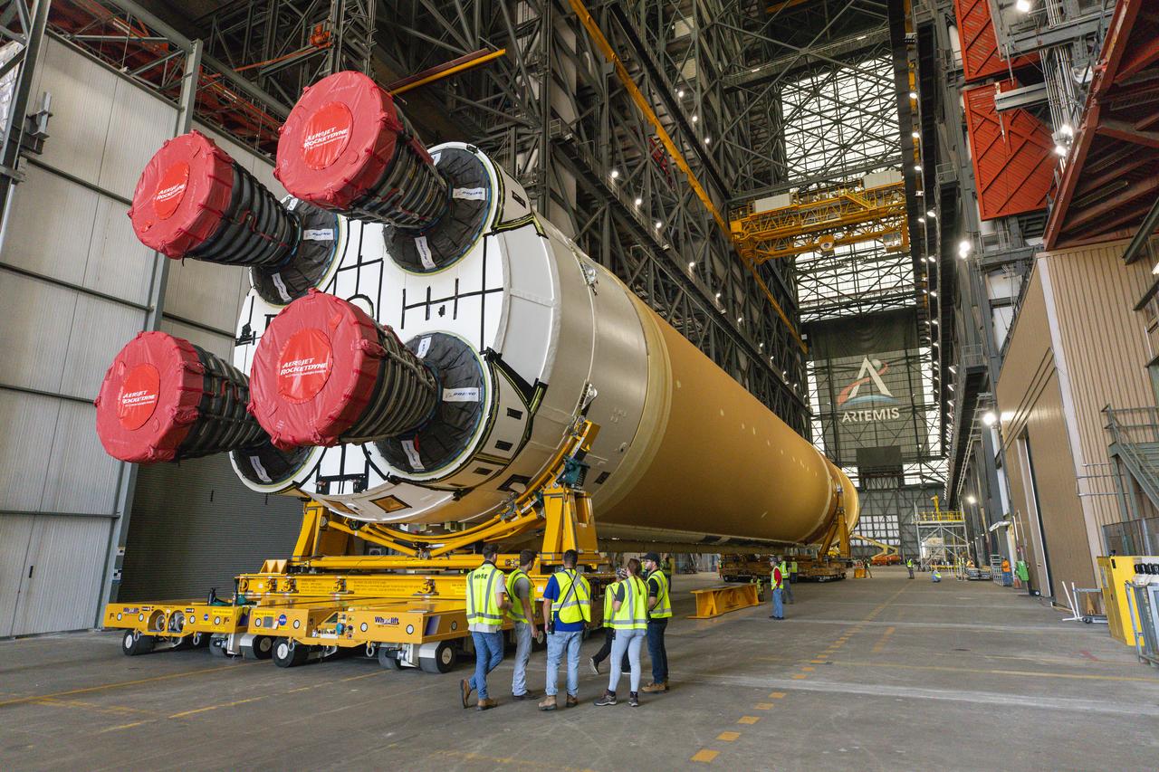 After completing its journey from NASA’s Michoud Assembly Facility in New Orleans aboard the Pegasus barge, teams with Exploration Ground Systems (EGS) transport the agency’s powerful SLS (Space Launch System) core stage into the transfer aisle inside Kennedy Space Center’s Vehicle Assembly Building in Florida on Wednesday, July 24, 2024. In the coming months, SLS will be prepared for integration atop the mobile launcher ahead of the Artemis II launch.
