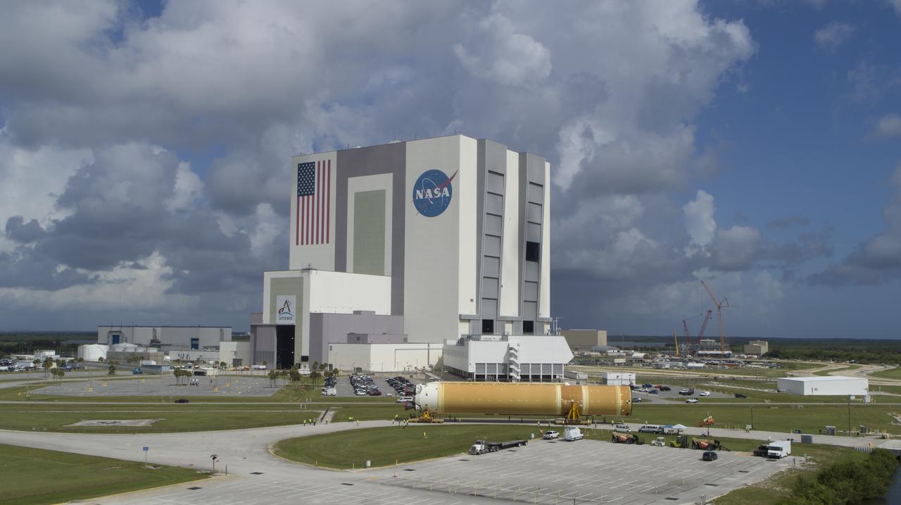 In this aerial view, teams with Exploration Ground Systems (EGS) transport the agency’s powerful SLS (Space Launch System) core stage to the Vehicle Assembly Building at NASA’s Kennedy Space Center in Florida on Wednesday, July 24, 2024, after it completed the journey from NASA’s Michoud Assembly Facility in New Orleans aboard the Pegasus barge. In the coming months, SLS will be prepared for integration atop the mobile launcher ahead of the Artemis II launch. 
