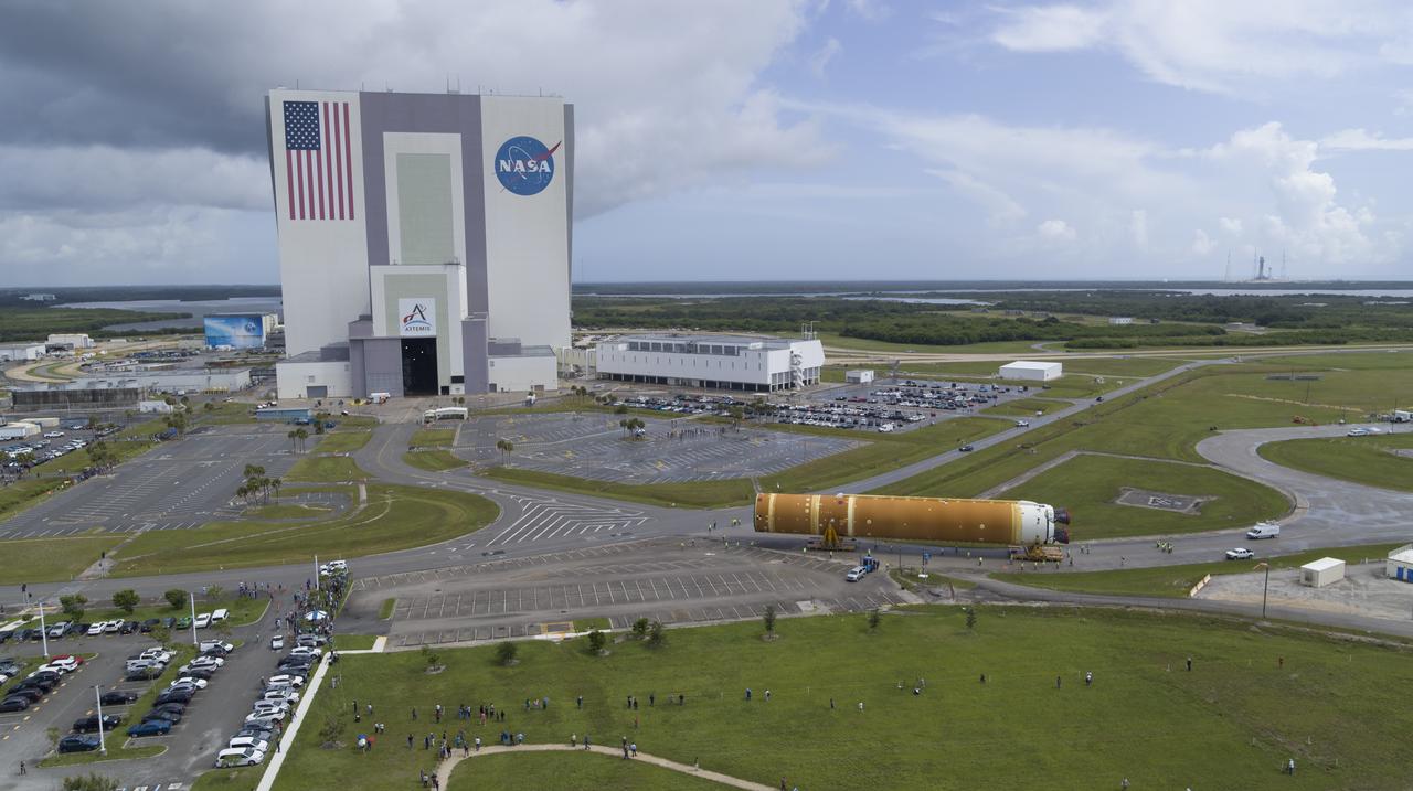 In this aerial view, teams with Exploration Ground Systems (EGS) transport the agency’s powerful SLS (Space Launch System) core stage to the Vehicle Assembly Building at NASA’s Kennedy Space Center in Florida on Wednesday, July 24, 2024, after it completed the journey from NASA’s Michoud Assembly Facility in New Orleans aboard the Pegasus barge. In the coming months, SLS will be prepared for integration atop the mobile launcher ahead of the Artemis II launch. 