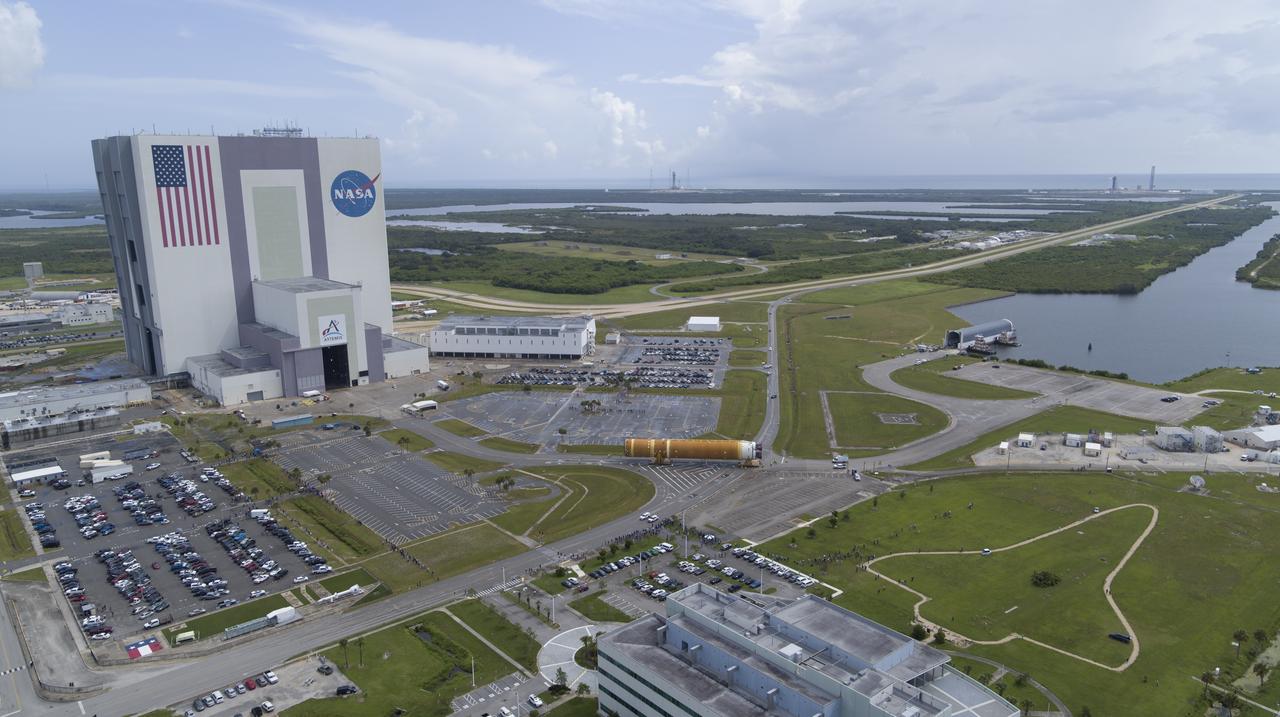 In this aerial view, teams with Exploration Ground Systems (EGS) transport the agency’s powerful SLS (Space Launch System) core stage to the Vehicle Assembly Building at NASA’s Kennedy Space Center in Florida on Wednesday, July 24, 2024, after it completed the journey from NASA’s Michoud Assembly Facility in New Orleans aboard the Pegasus barge. In the coming months, SLS will be prepared for integration atop the mobile launcher ahead of the Artemis II launch. 