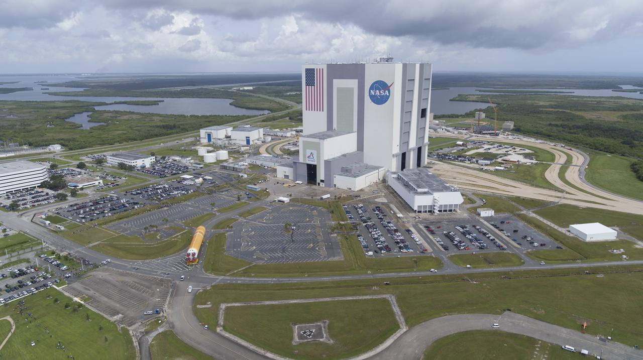 In this aerial view, teams with Exploration Ground Systems (EGS) transport the agency’s powerful SLS (Space Launch System) core stage to the Vehicle Assembly Building at NASA’s Kennedy Space Center in Florida on Wednesday, July 24, 2024, after it completed the journey from NASA’s Michoud Assembly Facility in New Orleans aboard the Pegasus barge. In the coming months, SLS will be prepared for integration atop the mobile launcher ahead of the Artemis II launch. 
