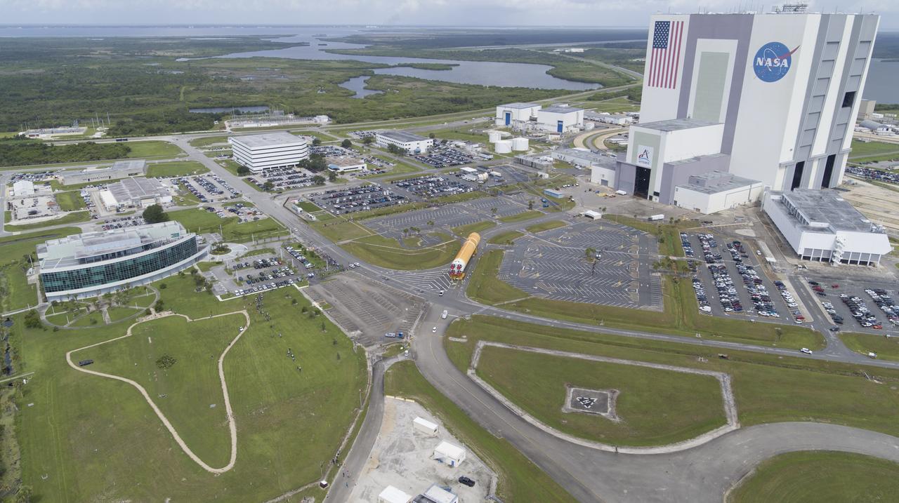 In this aerial view, teams with Exploration Ground Systems (EGS) transport the agency’s powerful SLS (Space Launch System) core stage to the Vehicle Assembly Building at NASA’s Kennedy Space Center in Florida on Wednesday, July 24, 2024, after it completed the journey from NASA’s Michoud Assembly Facility in New Orleans aboard the Pegasus barge. In the coming months, SLS will be prepared for integration atop the mobile launcher ahead of the Artemis II launch. 