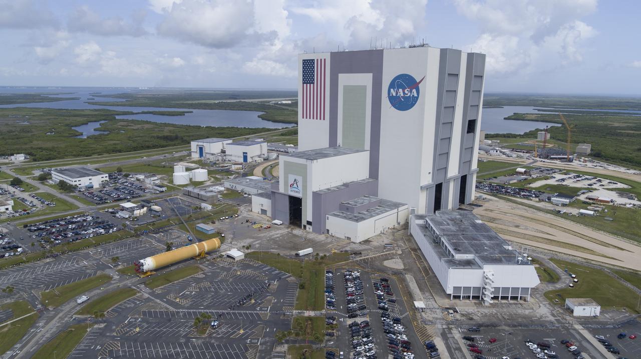 In this aerial view, teams with Exploration Ground Systems (EGS) transport the agency’s powerful SLS (Space Launch System) core stage to the Vehicle Assembly Building at NASA’s Kennedy Space Center in Florida on Wednesday, July 24, 2024, after it completed the journey from NASA’s Michoud Assembly Facility in New Orleans aboard the Pegasus barge. In the coming months, SLS will be prepared for integration atop the mobile launcher ahead of the Artemis II launch. 