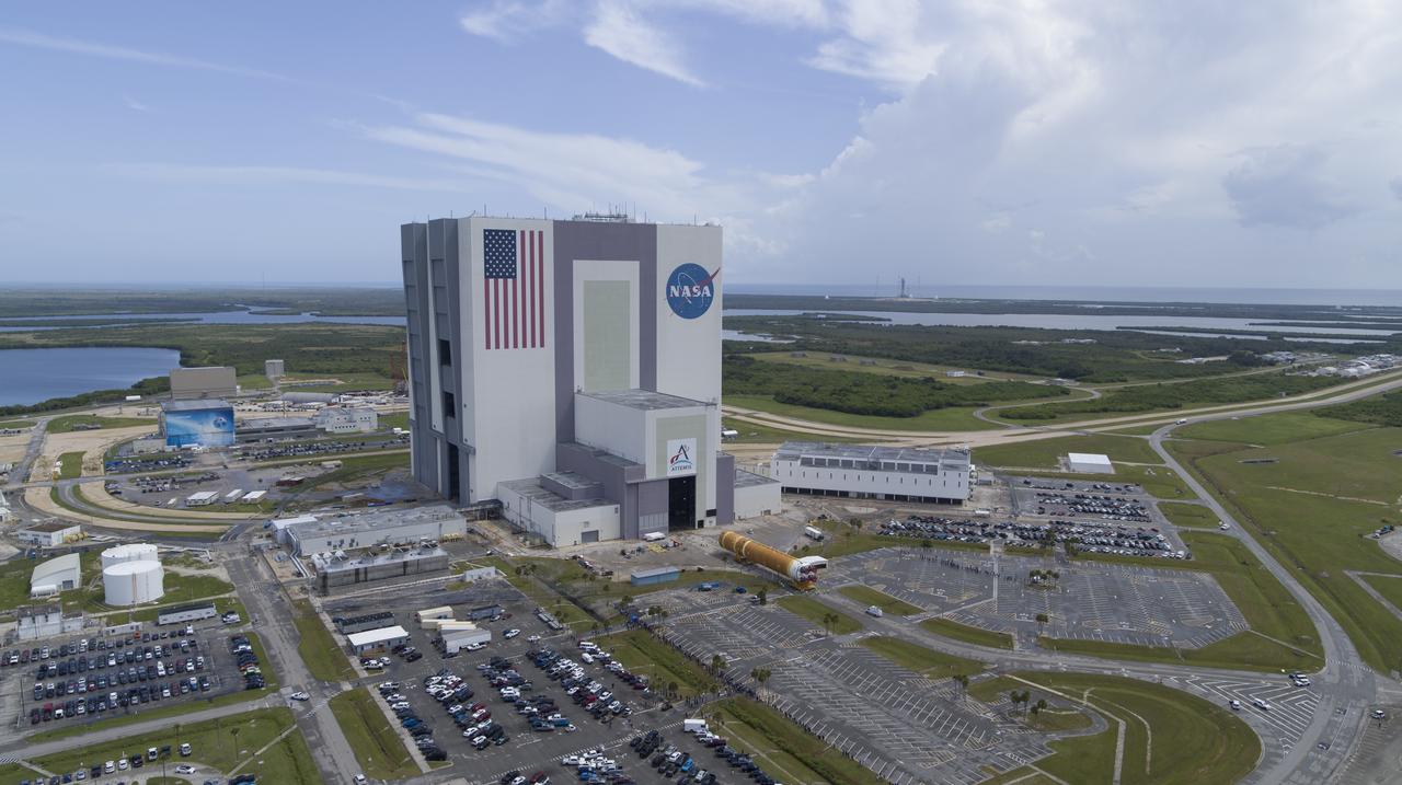 In this aerial view, teams with Exploration Ground Systems (EGS) transport the agency’s powerful SLS (Space Launch System) core stage to the Vehicle Assembly Building at NASA’s Kennedy Space Center in Florida on Wednesday, July 24, 2024, after it completed the journey from NASA’s Michoud Assembly Facility in New Orleans aboard the Pegasus barge. In the coming months, SLS will be prepared for integration atop the mobile launcher ahead of the Artemis II launch. 