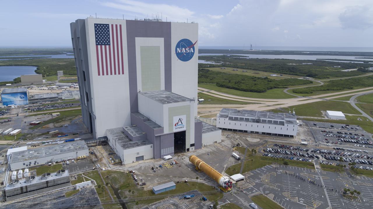 In this aerial view, teams with Exploration Ground Systems (EGS) transport the agency’s powerful SLS (Space Launch System) core stage to the Vehicle Assembly Building at NASA’s Kennedy Space Center in Florida on Wednesday, July 24, 2024, after it completed the journey from NASA’s Michoud Assembly Facility in New Orleans aboard the Pegasus barge. In the coming months, SLS will be prepared for integration atop the mobile launcher ahead of the Artemis II launch. 