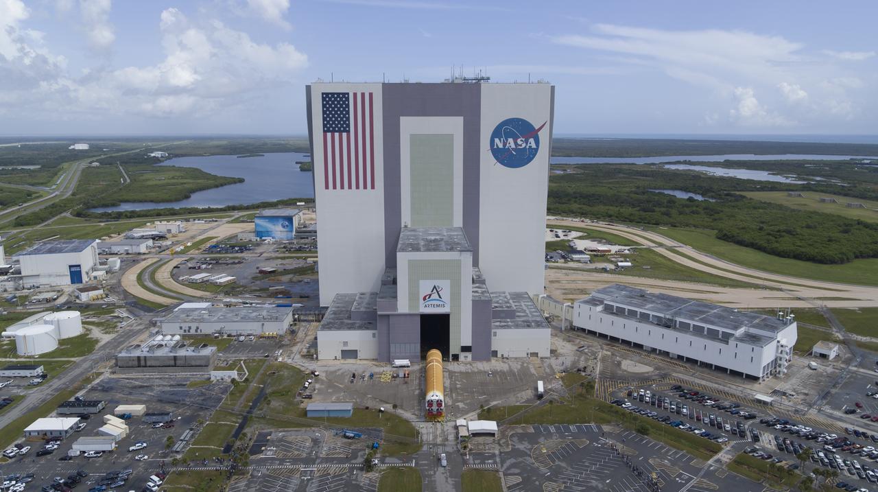 In this aerial view, teams with Exploration Ground Systems (EGS) transport the agency’s powerful SLS (Space Launch System) core stage to the Vehicle Assembly Building at NASA’s Kennedy Space Center in Florida on Wednesday, July 24, 2024, after it completed the journey from NASA’s Michoud Assembly Facility in New Orleans aboard the Pegasus barge. In the coming months, SLS will be prepared for integration atop the mobile launcher ahead of the Artemis II launch. 