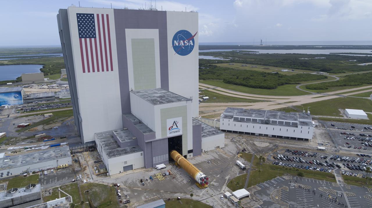 In this aerial view, teams with Exploration Ground Systems (EGS) transport the agency’s powerful SLS (Space Launch System) core stage to the Vehicle Assembly Building at NASA’s Kennedy Space Center in Florida on Wednesday, July 24, 2024, after it completed the journey from NASA’s Michoud Assembly Facility in New Orleans aboard the Pegasus barge. In the coming months, SLS will be prepared for integration atop the mobile launcher ahead of the Artemis II launch. 