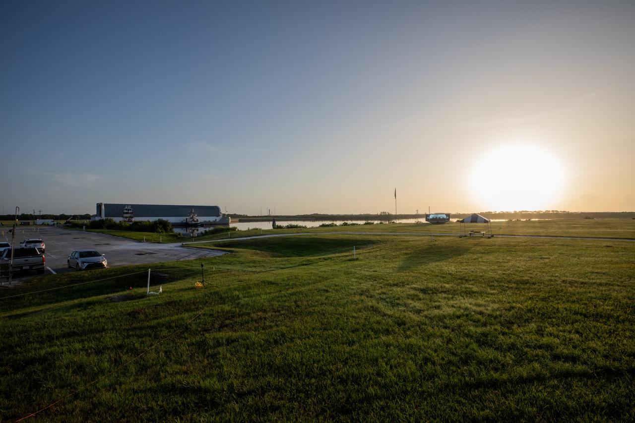 The sun rises over NASA’s Pegasus barge, carrying the agency’s massive SLS (Space Launch System) core stage, at NASA’s Kennedy Space Center Complex 39 turn basin wharf in Florida on Wednesday, July 24, 2024, after journeying from the agency’s Michoud Assembly Facility in New Orleans. The core stage is the next piece of Artemis hardware to arrive at the spaceport and will be offloaded and moved to NASA Kennedy’s Vehicle Assembly Building, where it will be prepared for integration ahead of the Artemis II launch.