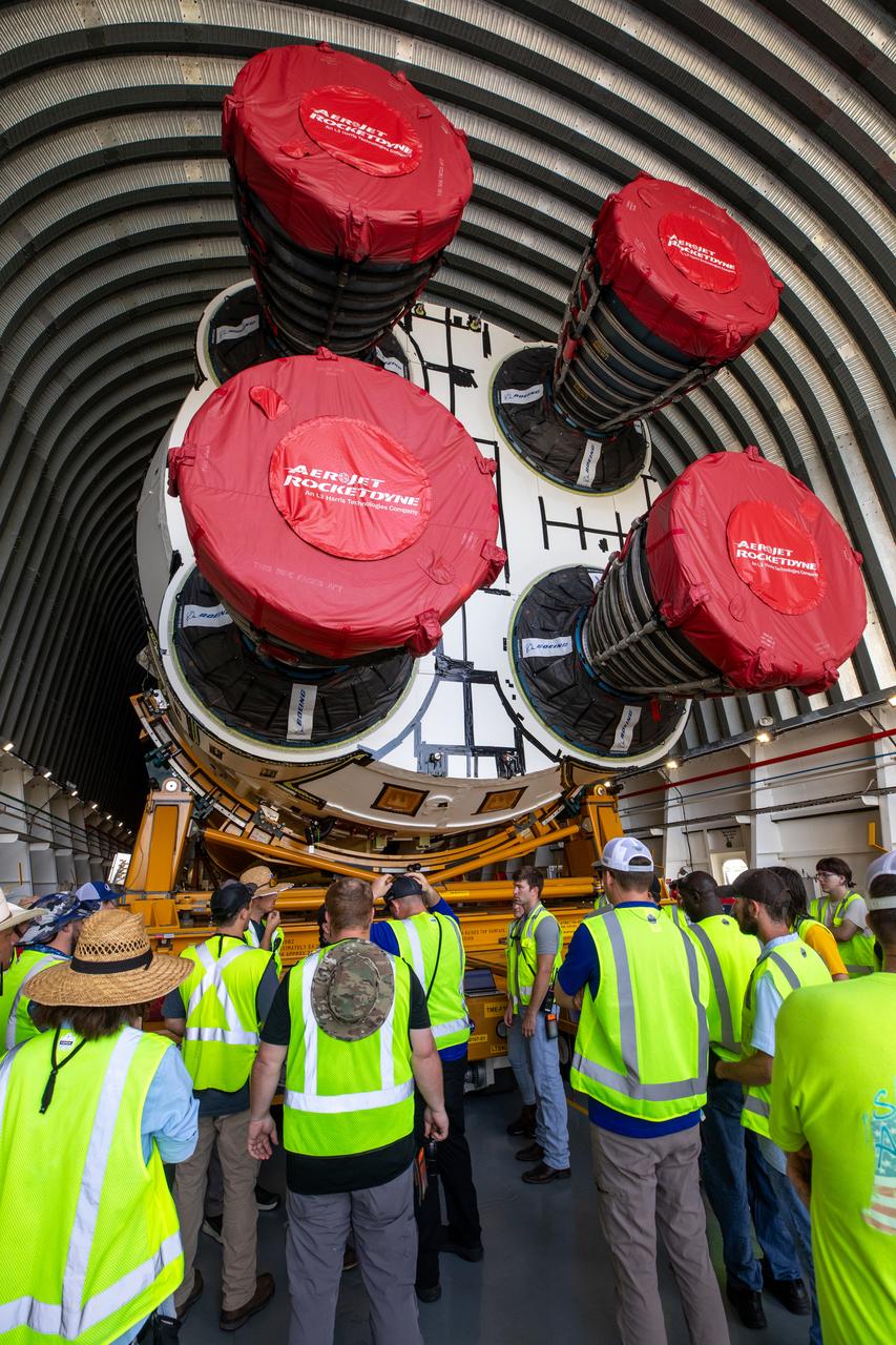 NASA’s massive 212-foot long SLS (Space Launch System) core stage is offloaded from the agency’s Pegasus Barge on Wednesday, July 24 2024, after arriving at NASA’s Kennedy Space Center in Florida. Teams with Exploration Ground Systems (EGS) will transfer the rocket stage to the spaceport’s Vehicle Assembly Building to prepare it for integration atop the mobile launcher ahead of the Artemis II launch.