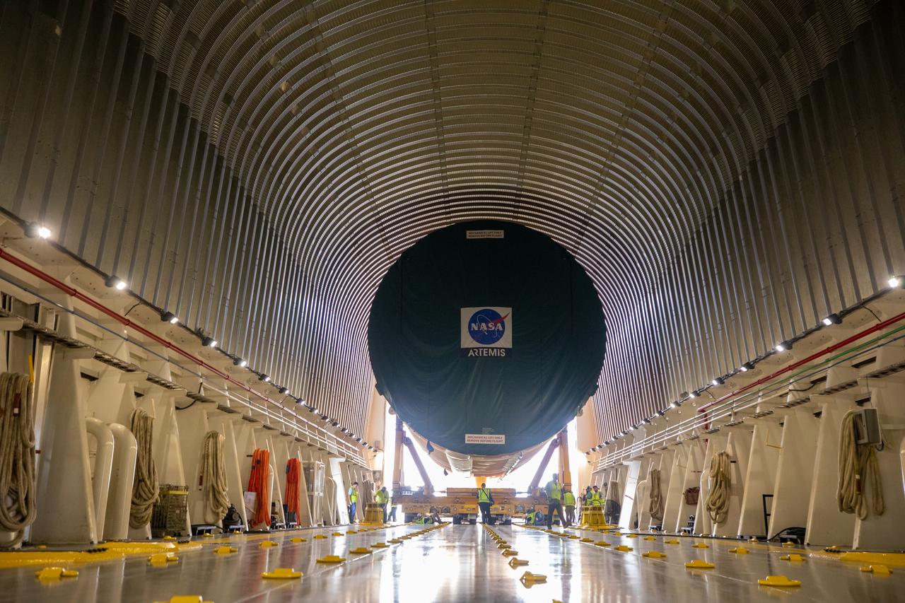 NASA’s massive 212-foot long SLS (Space Launch System) core stage is offloaded from the agency’s Pegasus Barge on Wednesday, July 24, 2024, after arriving at NASA’s Kennedy Space Center in Florida. Teams with Exploration Ground Systems (EGS) will transfer the rocket stage to the spaceport’s Vehicle Assembly Building to prepare it for integration atop the mobile launcher ahead of the Artemis II launch.