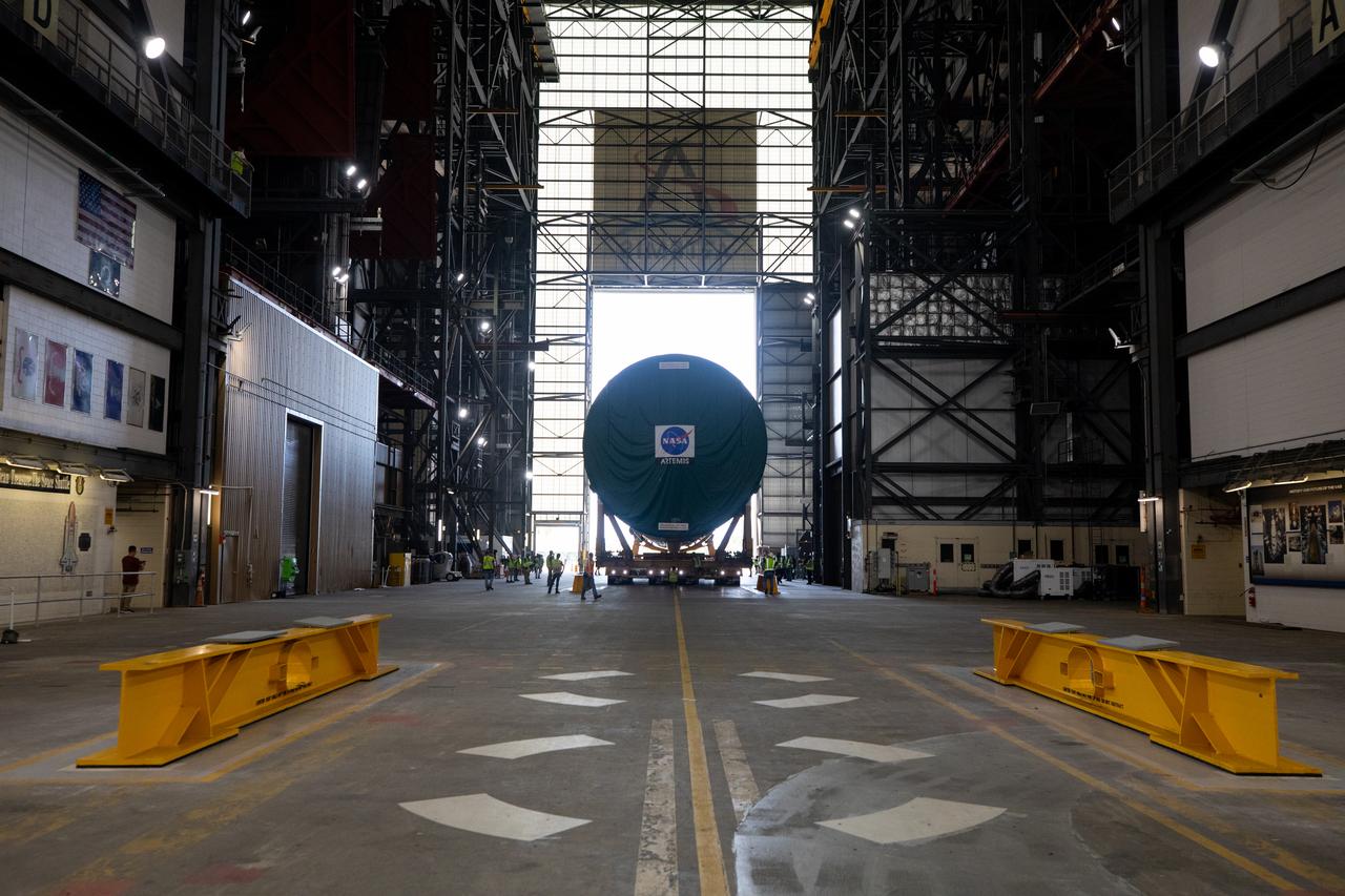 After completing its journey from NASA’s Michoud Assembly Facility in New Orleans aboard the Pegasus barge, teams with Exploration Ground Systems (EGS) transport the agency’s powerful SLS (Space Launch System) core stage into the transfer aisle inside the Vehicle Assembly Building at NASA’s Kennedy Space Center in Florida on Wednesday, July 24, 2024. In the coming months, SLS will be prepared for integration atop the mobile launcher ahead of the Artemis II launch. 