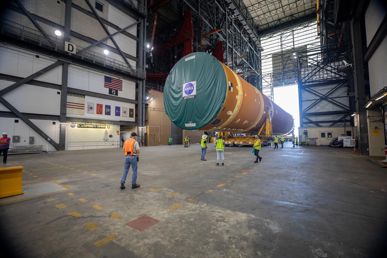 After completing its journey from NASA’s Michoud Assembly Facility in New Orleans aboard the Pegasus barge, teams with Exploration Ground Systems (EGS) transport the agency’s powerful SLS (Space Launch System) core stage into the transfer aisle inside the Vehicle Assembly Building at NASA’s Kennedy Space Center in Florida on Wednesday, July 24, 2024. In the coming months, SLS will be prepared for integration atop the mobile launcher ahead of the Artemis II launch. 