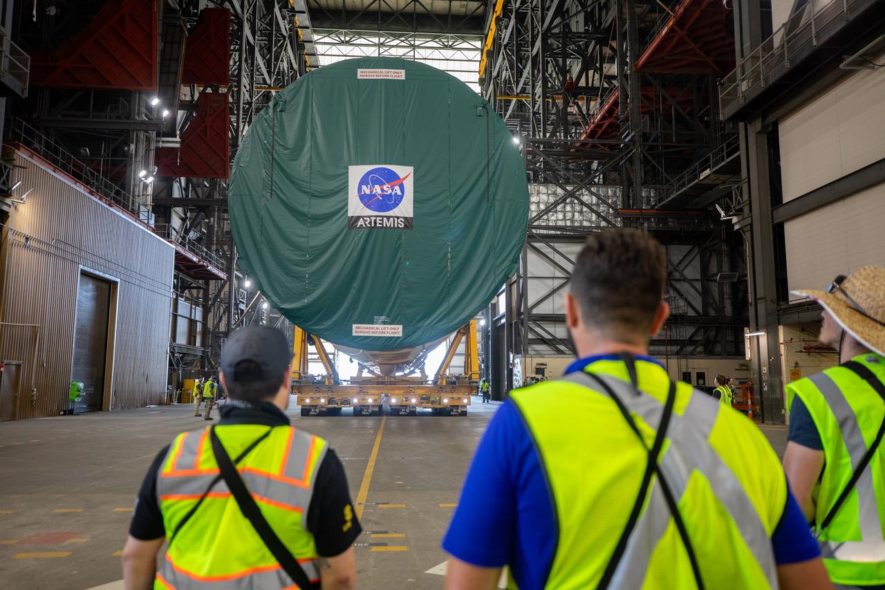 After completing its journey from NASA’s Michoud Assembly Facility in New Orleans aboard the Pegasus barge, teams with Exploration Ground Systems (EGS) transport the agency’s powerful SLS (Space Launch System) core stage into the transfer aisle inside the Vehicle Assembly Building at NASA’s Kennedy Space Center in Florida on Wednesday, July 24, 2024. In the coming months, SLS will be prepared for integration atop the mobile launcher ahead of the Artemis II launch. 