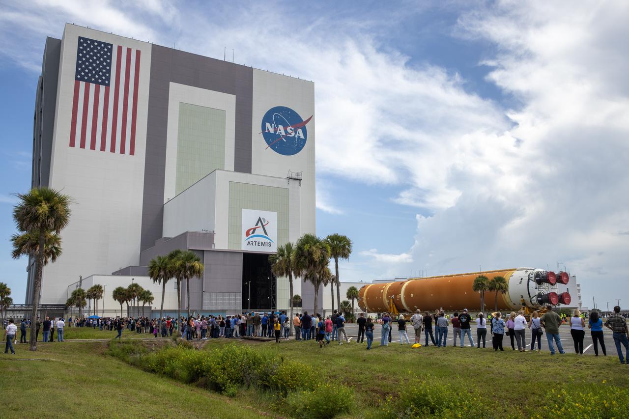Employees from NASA’s Kennedy Space Center in Florida watch as teams with Exploration Ground Systems (EGS) transport the agency’s powerful SLS (Space Launch System) core stage to the spaceport’s Vehicle Assembly Building on Wednesday, July 24, 2024. The 212-foot-long rocket stage completed its journey from NASA’s Michoud Assembly Facility in New Orleans aboard the Pegasus barge the previous day. Once inside, SLS will be prepared for integration atop the mobile launcher ahead of the Artemis II launch.