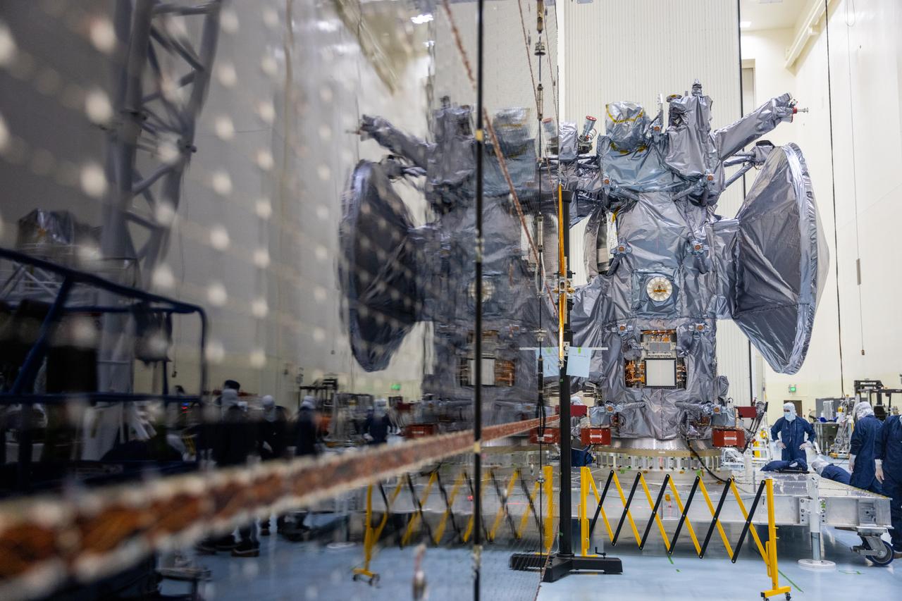 Technicians move NASA’s Europa Clipper spacecraft inside the Payload Hazardous Servicing Facility to accommodate installation of its five-panel solar array at the agency’s Kennedy Space Center in Florida on Thursday, Aug. 1, 2024. After moving the spacecraft, the team had to precisely align the spacecraft in preparation for the installation. The huge arrays – spanning more than 100 feet when fully deployed, or about the length of a basketball court – will collect sunlight to power the spacecraft as it flies multiple times around Jupiter’s icy moon, Europa, conducting science investigations to determine its potential to support life.
