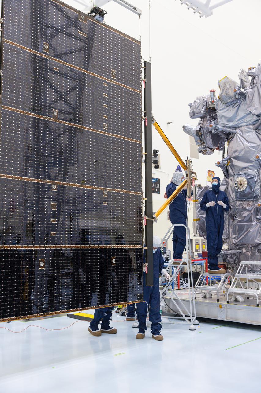 Technicians attach the five-panel solar arrays to NASA’s Europa Clipper spacecraft inside the Payload Hazardous Servicing Facility at the agency’s Kennedy Space Center in Florida on Friday, Aug. 2, 2024. The huge arrays – spanning more than 100 feet when fully deployed, or about the length of a basketball court – will collect sunlight to power the spacecraft as it explores Jupiter’s icy moon, Europa, conducting science investigations to determine its potential to support life.