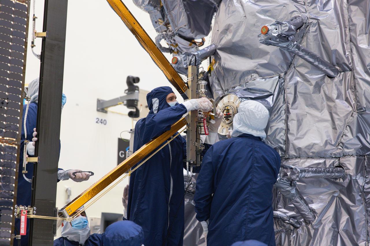 Technicians attach the five-panel solar arrays to NASA’s Europa Clipper spacecraft inside the Payload Hazardous Servicing Facility at the agency’s Kennedy Space Center in Florida on Friday, Aug. 2, 2024. The huge arrays – spanning more than 100 feet when fully deployed, or about the length of a basketball court – will collect sunlight to power the spacecraft as it explores Jupiter’s icy moon, Europa, conducting science investigations to determine its potential to support life.