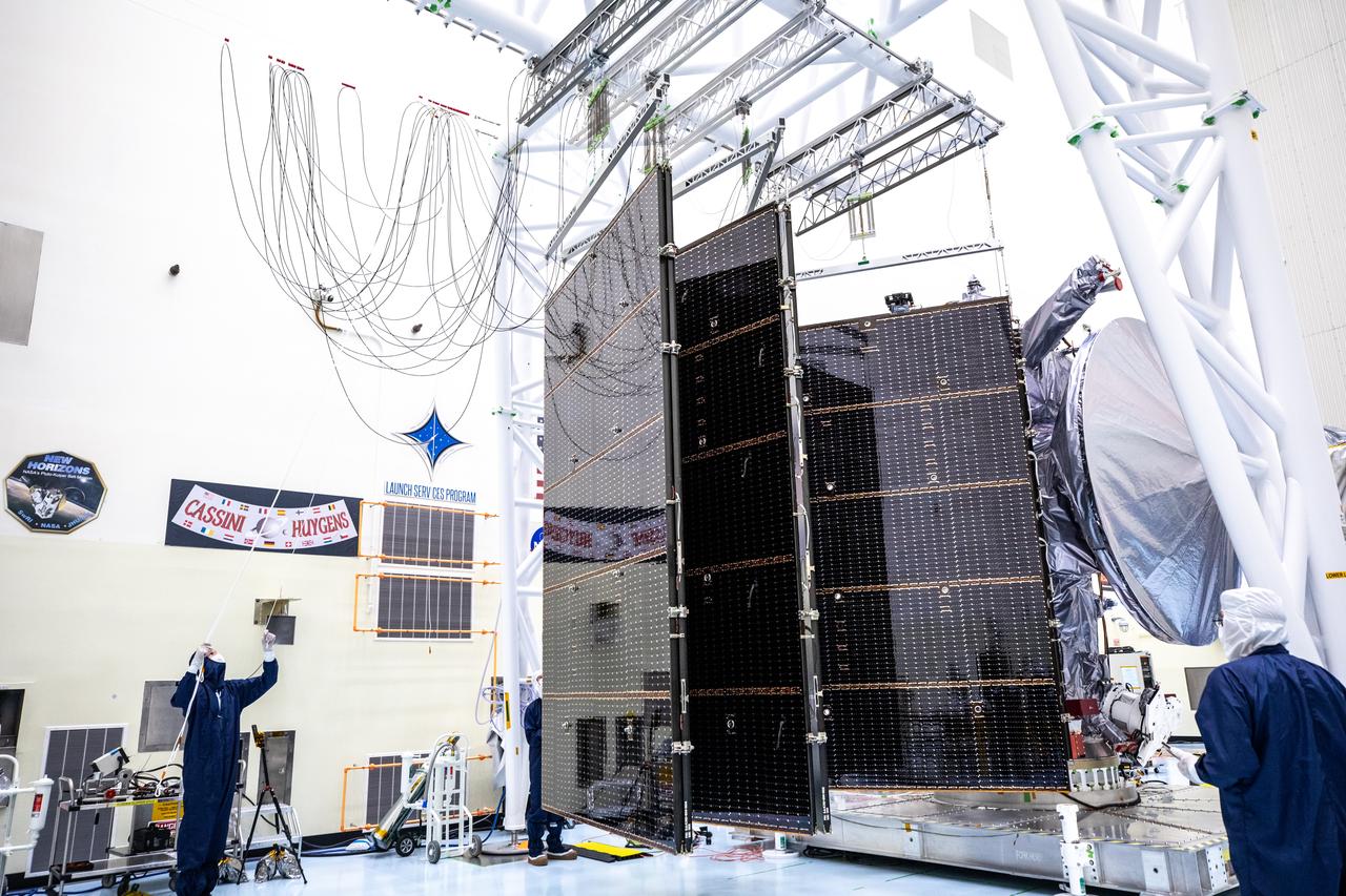 Technicians tested deploying a set of massive solar arrays measuring about 46.5 feet (14.2 meters) long and about 13.5 feet (4.1 meters) high for NASA’s Europa Clipper spacecraft inside the agency’s Payload Hazardous Servicing Facility at Kennedy Space Center in Florida on Wednesday, Aug. 7, 2024. Once launched to study Jupiter’s icy moon, Europa, the solar arrays will fully extend to power the spacecraft to perform  flybys to gather science and data to determine if the moon can support habitable conditions. 