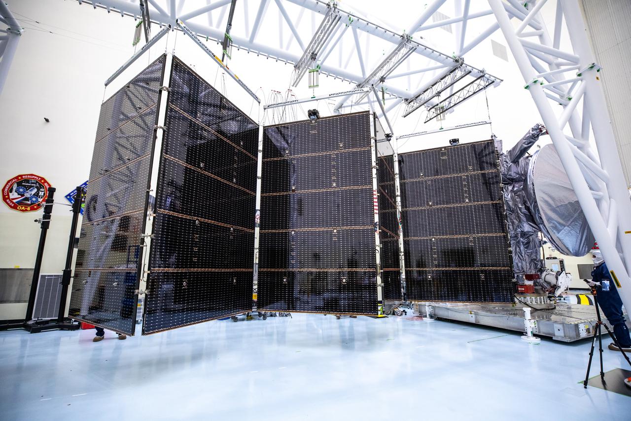 Technicians tested deploying a set of massive solar arrays measuring about 46.5 feet (14.2 meters) long and about 13.5 feet (4.1 meters) high for NASA’s Europa Clipper spacecraft inside the agency’s Payload Hazardous Servicing Facility at Kennedy Space Center in Florida on Wednesday, Aug. 7, 2024. Once launched to study Jupiter’s icy moon, Europa, the solar arrays will fully extend to power the spacecraft to perform  flybys to gather science and data to determine if the moon can support habitable conditions. 
