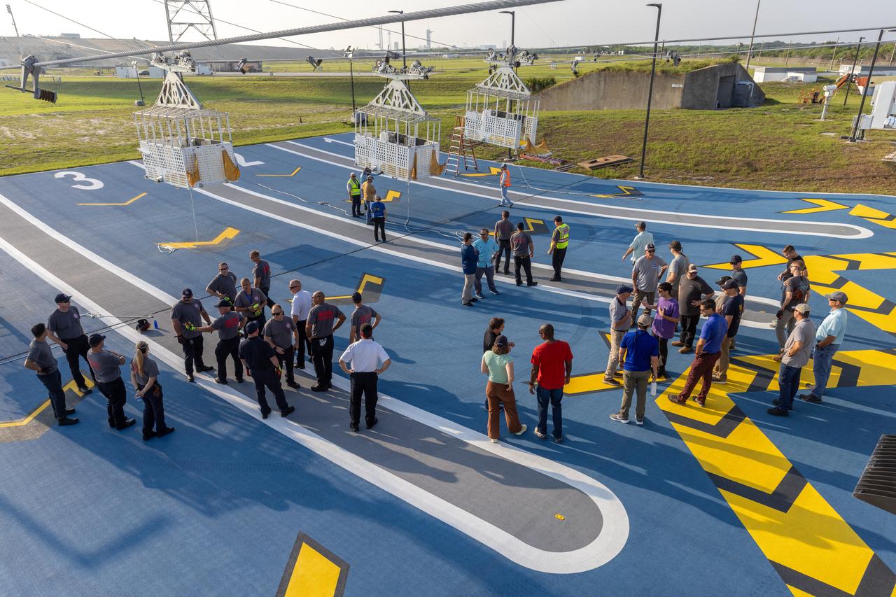 Teams at NASA’s Kennedy Space Center in Florida practice the Artemis mission emergency procedures during a series of integrated system verification and validation tests at Launch Pad 39B on Friday, Aug. 9, 2024. Members of the closeout crew, pad rescue team, and the Exploration Ground Systems Program practiced the process of getting inside and out of the emergency egress baskets. While the crew and other personnel will ride the emergency egress baskets to the terminus area in a real emergency, no one rode the baskets for this test. Instead, teams tested the baskets during separate occasions by using water tanks filled to different levels to replicate simulate the weight of passengers. 