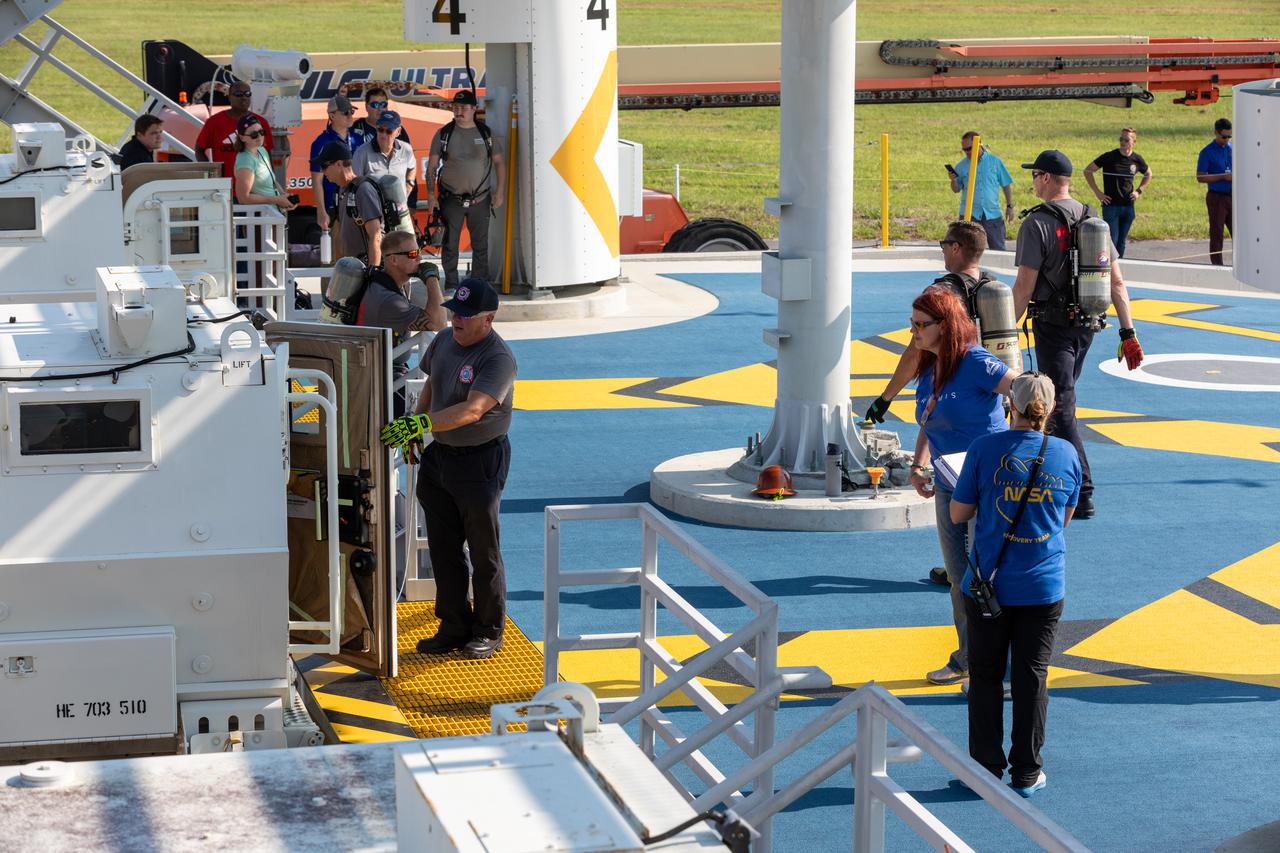 Teams at NASA’s Kennedy Space Center in Florida practice the Artemis mission emergency procedures during a series of integrated system verification and validation tests at Launch Pad 39B on Friday, Aug. 9, 2024. Members of the closeout crew, pad rescue team, and the Exploration Ground Systems Program practiced the process of getting inside and out of the emergency egress baskets. While the crew and other personnel will ride the emergency egress baskets to the terminus area in a real emergency, no one rode the baskets for this test. Instead, teams tested the baskets during separate occasions by using water tanks filled to different levels to replicate simulate the weight of passengers. 