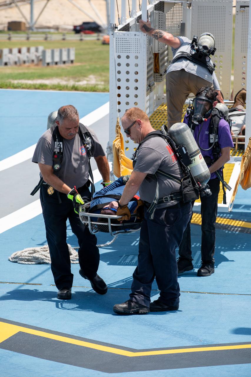 Teams at NASA’s Kennedy Space Center in Florida practice the Artemis mission emergency escape or egress procedures during a series of integrated system verification and validation tests at Launch Complex 39B on Friday, Aug. 9, 2024. Members of the closeout crew, pad rescue team, and the Exploration Ground Systems Program practiced the process of getting in and out of the emergency egress baskets then down to the launch pad where they would be transported to emergency transport vehicles and driven to safety. Prior to this test and throughout the course of several months, teams conducted several basket release demonstrations to validate the system.