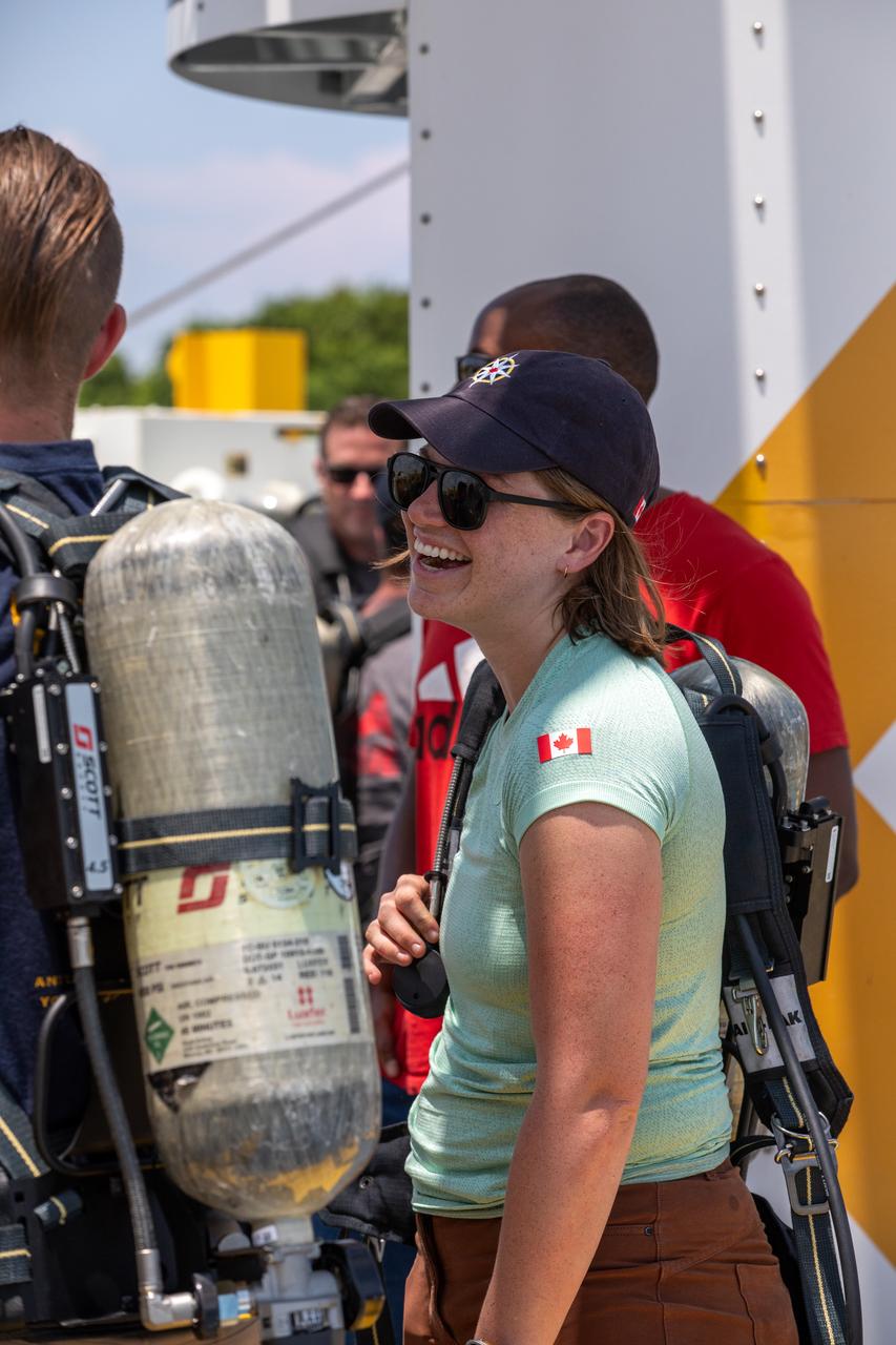 Canadian Space Agency (CSA) astronaut Jenni Gibbons, who is CSA astronaut Jeremy Hansen's backup for the Artemis II crew mission, participates in the Artemis emergency egress demonstration at Launch Complex 39B on Friday, Aug. 9, 2024, at NASA's Kennedy Space Center in Florida. Gibbons participated as one of the astronaut support personnel, part of the closeout crew, practiced the process of getting in and out of the emergency egress baskets then down to the launch pad where they would be transported to emergency transport vehicles and driven to safety. Prior to this test and throughout the course of several months, teams conducted several basket release demonstrations to validate the system.