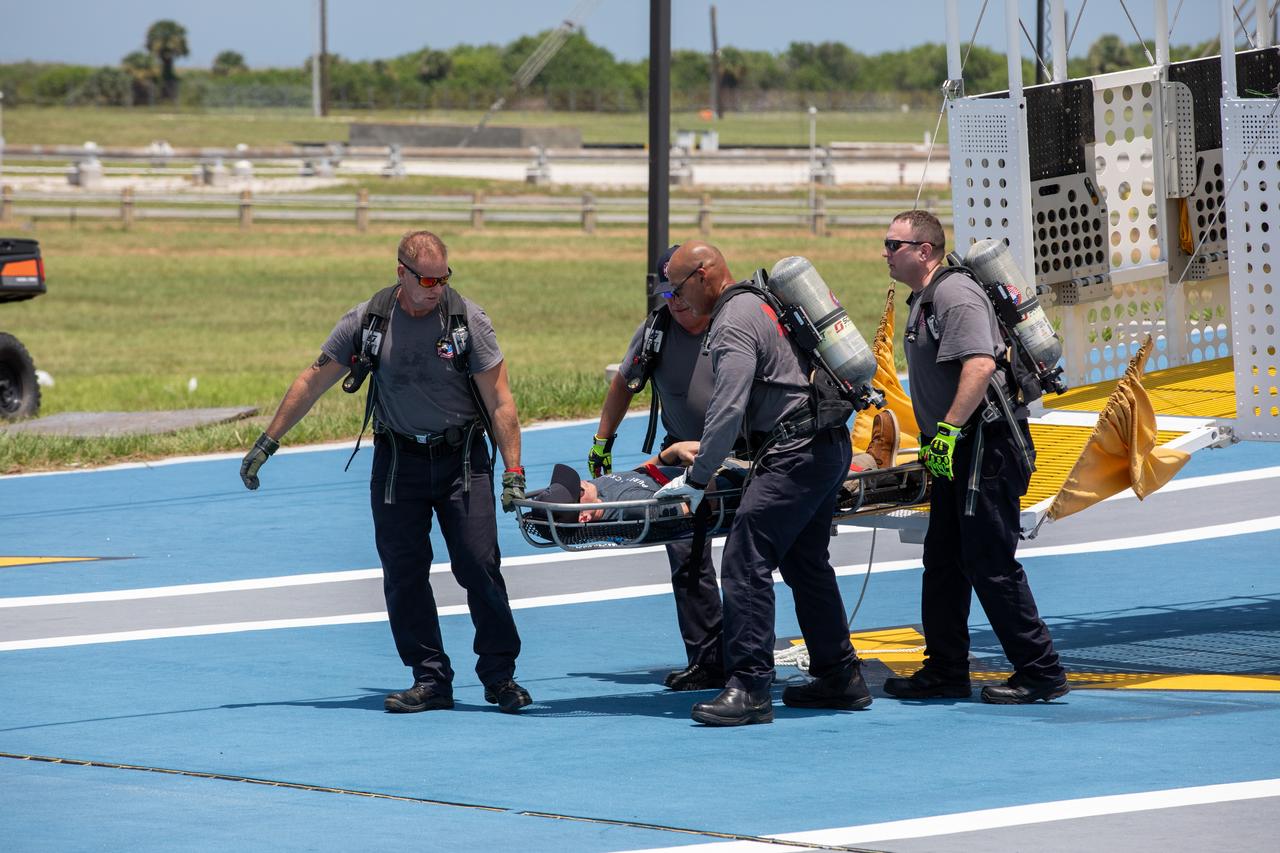 Teams at NASA’s Kennedy Space Center in Florida practice the Artemis mission emergency escape or egress procedures during a series of integrated system verification and validation tests at Launch Complex 39B on Friday, Aug. 9, 2024. Members of the closeout crew, pad rescue team, and the Exploration Ground Systems Program practiced the process of getting in and out of the emergency egress baskets then down to the launch pad where they would be transported to emergency transport vehicles and driven to safety. Prior to this test and throughout the course of several months, teams conducted several basket release demonstrations to validate the system.