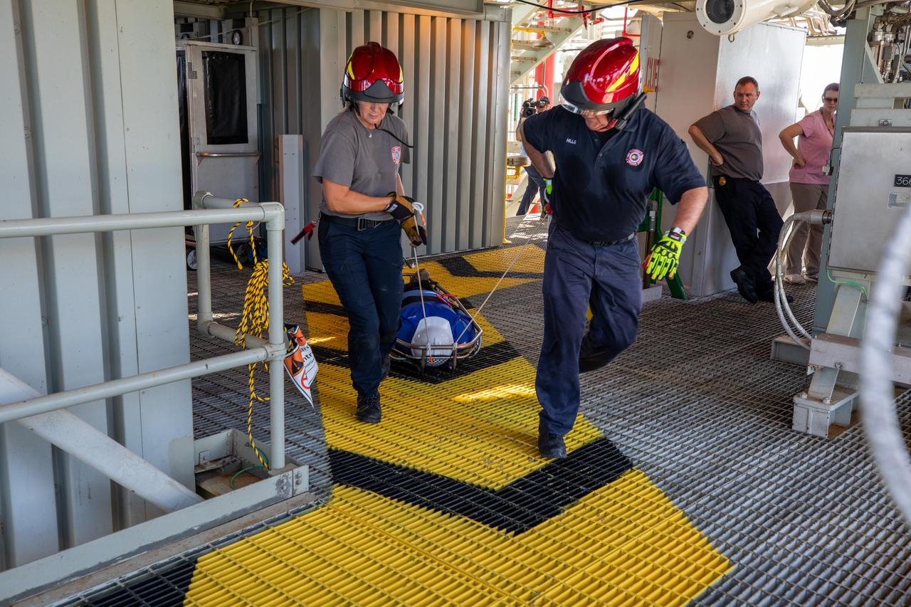Teams at NASA’s Kennedy Space Center in Florida practice the Artemis mission emergency escape or egress procedures during a series of integrated system verification and validation tests at Launch Pad 39B on Sunday, Aug. 11, 2024. Members of the closeout crew, pad rescue team and the Exploration Ground Systems Program practiced the process of getting inside and out of the emergency egress baskets. While the crew and other personnel will ride the emergency egress baskets to the terminus area in a real emergency, no one rode the baskets for this test. Instead, teams tested the baskets during separate occasions by using water tanks filled to different levels to replicate simulate the weight of passengers. 