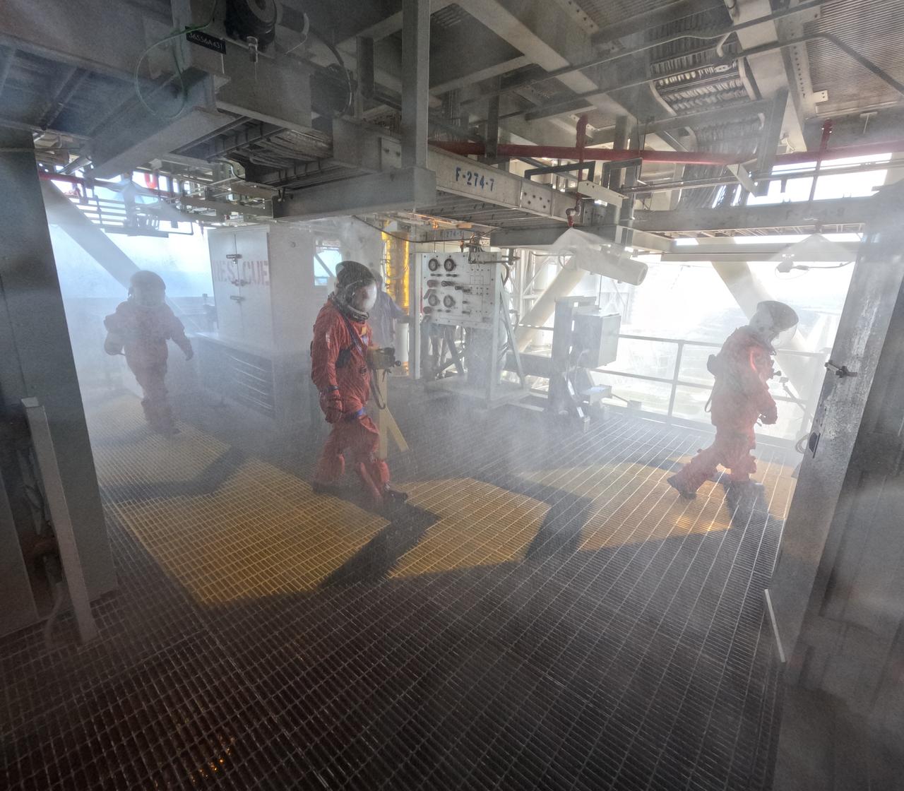 Teams at NASA’s Kennedy Space Center in Florida practice the Artemis mission emergency escape or egress procedures during a series of integrated system verification and validation tests at Launch Pad 39B on Sunday, Aug. 11, 2024. Members of the closeout crew, simulated flight crew, pad rescue team, and the Exploration Ground Systems Program practiced the process of getting inside and out of the emergency egress baskets. While the crew and other personnel will ride the emergency egress baskets to the terminus area in a real emergency, no one rode the baskets for this test. Instead, teams tested the baskets during separate occasions by using water tanks filled to different levels to replicate simulate the weight of passengers. 