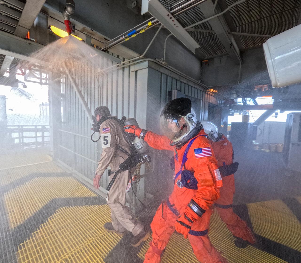 Teams at NASA’s Kennedy Space Center in Florida practice the Artemis mission emergency escape or egress procedures during a series of integrated system verification and validation tests at Launch Pad 39B on Sunday, Aug. 11, 2024. Members of the closeout crew, simulated flight crew, pad rescue team, and the Exploration Ground Systems Program practiced the process of getting inside and out of the emergency egress baskets. While the crew and other personnel will ride the emergency egress baskets to the terminus area in a real emergency, no one rode the baskets for this test. Instead, teams tested the baskets during separate occasions by using water tanks filled to different levels to replicate simulate the weight of passengers. 
