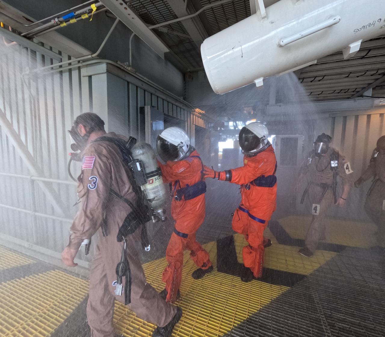 Teams at NASA’s Kennedy Space Center in Florida practice the Artemis mission emergency escape or egress procedures during a series of integrated system verification and validation tests at Launch Pad 39B on Sunday, Aug. 11, 2024. Members of the closeout crew, simulated flight crew, pad rescue team, and the Exploration Ground Systems Program practiced the process of getting inside and out of the emergency egress baskets. While the crew and other personnel will ride the emergency egress baskets to the terminus area in a real emergency, no one rode the baskets for this test. Instead, teams tested the baskets during separate occasions by using water tanks filled to different levels to replicate simulate the weight of passengers. 