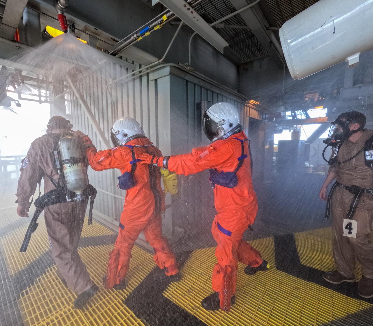 Teams at NASA’s Kennedy Space Center in Florida practice the Artemis mission emergency escape or egress procedures during a series of integrated system verification and validation tests at Launch Pad 39B on Sunday, Aug. 11, 2024. Members of the closeout crew, simulated flight crew, pad rescue team, and the Exploration Ground Systems Program practiced the process of getting inside and out of the emergency egress baskets. While the crew and other personnel will ride the emergency egress baskets to the terminus area in a real emergency, no one rode the baskets for this test. Instead, teams tested the baskets during separate occasions by using water tanks filled to different levels to replicate simulate the weight of passengers. 