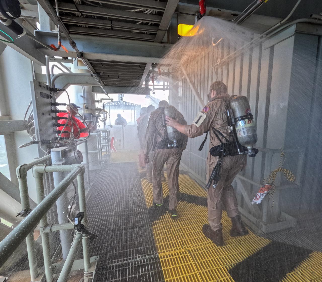 Teams at NASA’s Kennedy Space Center in Florida practice the Artemis mission emergency escape or egress procedures during a series of integrated system verification and validation tests at Launch Pad 39B on Sunday, Aug. 11, 2024. Members of the closeout crew, simulated flight crew, pad rescue team, and the Exploration Ground Systems Program practiced the process of getting inside and out of the emergency egress baskets. While the crew and other personnel will ride the emergency egress baskets to the terminus area in a real emergency, no one rode the baskets for this test. Instead, teams tested the baskets during separate occasions by using water tanks filled to different levels to replicate simulate the weight of passengers. 