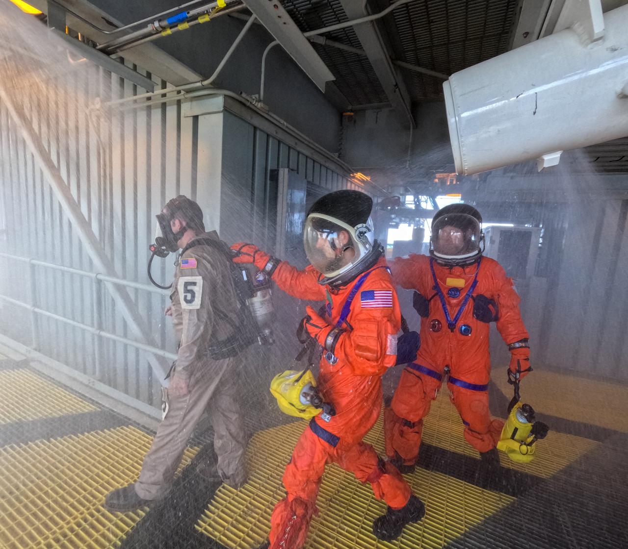 Teams at NASA’s Kennedy Space Center in Florida practice the Artemis mission emergency escape or egress procedures during a series of integrated system verification and validation tests at Launch Pad 39B on Sunday, Aug. 11, 2024. Members of the closeout crew, simulated flight crew, pad rescue team, and the Exploration Ground Systems Program practiced the process of getting inside and out of the emergency egress baskets. While the crew and other personnel will ride the emergency egress baskets to the terminus area in a real emergency, no one rode the baskets for this test. Instead, teams tested the baskets during separate occasions by using water tanks filled to different levels to replicate simulate the weight of passengers. 