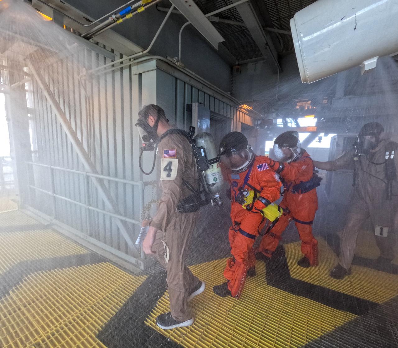 Teams at NASA’s Kennedy Space Center in Florida practice the Artemis mission emergency escape or egress procedures during a series of integrated system verification and validation tests at Launch Pad 39B on Sunday, Aug. 11, 2024. Members of the closeout crew, simulated flight crew, pad rescue team, and the Exploration Ground Systems Program practiced the process of getting inside and out of the emergency egress baskets. While the crew and other personnel will ride the emergency egress baskets to the terminus area in a real emergency, no one rode the baskets for this test. Instead, teams tested the baskets during separate occasions by using water tanks filled to different levels to replicate simulate the weight of passengers. 