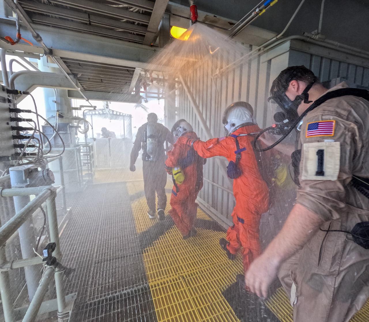 Teams at NASA’s Kennedy Space Center in Florida practice the Artemis mission emergency escape or egress procedures during a series of integrated system verification and validation tests at Launch Pad 39B on Sunday, Aug. 11, 2024. Members of the closeout crew, simulated flight crew, pad rescue team, and the Exploration Ground Systems Program practiced the process of getting inside and out of the emergency egress baskets. While the crew and other personnel will ride the emergency egress baskets to the terminus area in a real emergency, no one rode the baskets for this test. Instead, teams tested the baskets during separate occasions by using water tanks filled to different levels to replicate simulate the weight of passengers. 