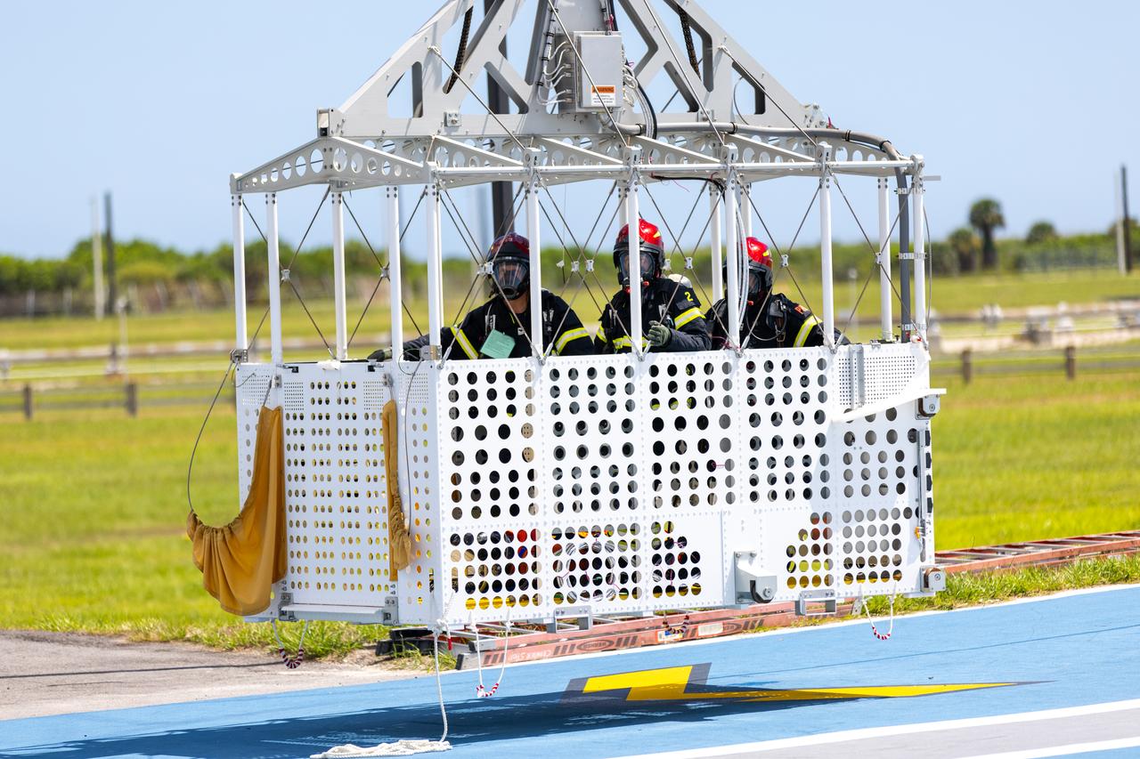 Teams at NASA’s Kennedy Space Center in Florida practice the Artemis mission emergency escape or egress procedures during a series of integrated system verification and validation tests at Launch Pad 39B on Monday, Aug. 12, 2024. Members of the closeout crew, pad rescue team and the Exploration Ground Systems Program practiced the process of getting inside and out of the emergency egress baskets. While the crew and other personnel will ride the emergency egress baskets to the terminus area in a real emergency, no one rode the baskets for this test. Instead, teams tested the baskets during separate occasions by using water tanks filled to different levels to replicate simulate the weight of passengers.