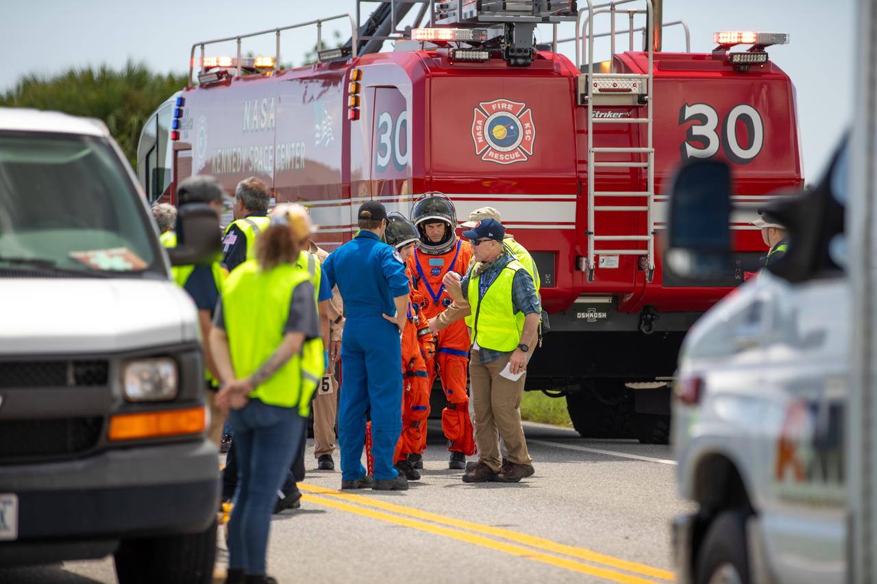 Medical, fire-rescue personnel, and simulated flight crew members participate in the Artemis II mission emergency escape or egress verification and validation tests near Launch Complex 39 at NASA's Kennedy Space Center in Florida on Monday, Aug. 12, 2024. During the multi-day tests, members of the closeout crew, pad rescue team, and the Exploration Ground Systems Program practiced the process of getting in and out of the emergency egress baskets then down to the launch pad where they would be transported to emergency transport vehicles and driven to safety. Prior to this test and throughout the course of several months, teams conducted basket release demonstrations to validate the system.