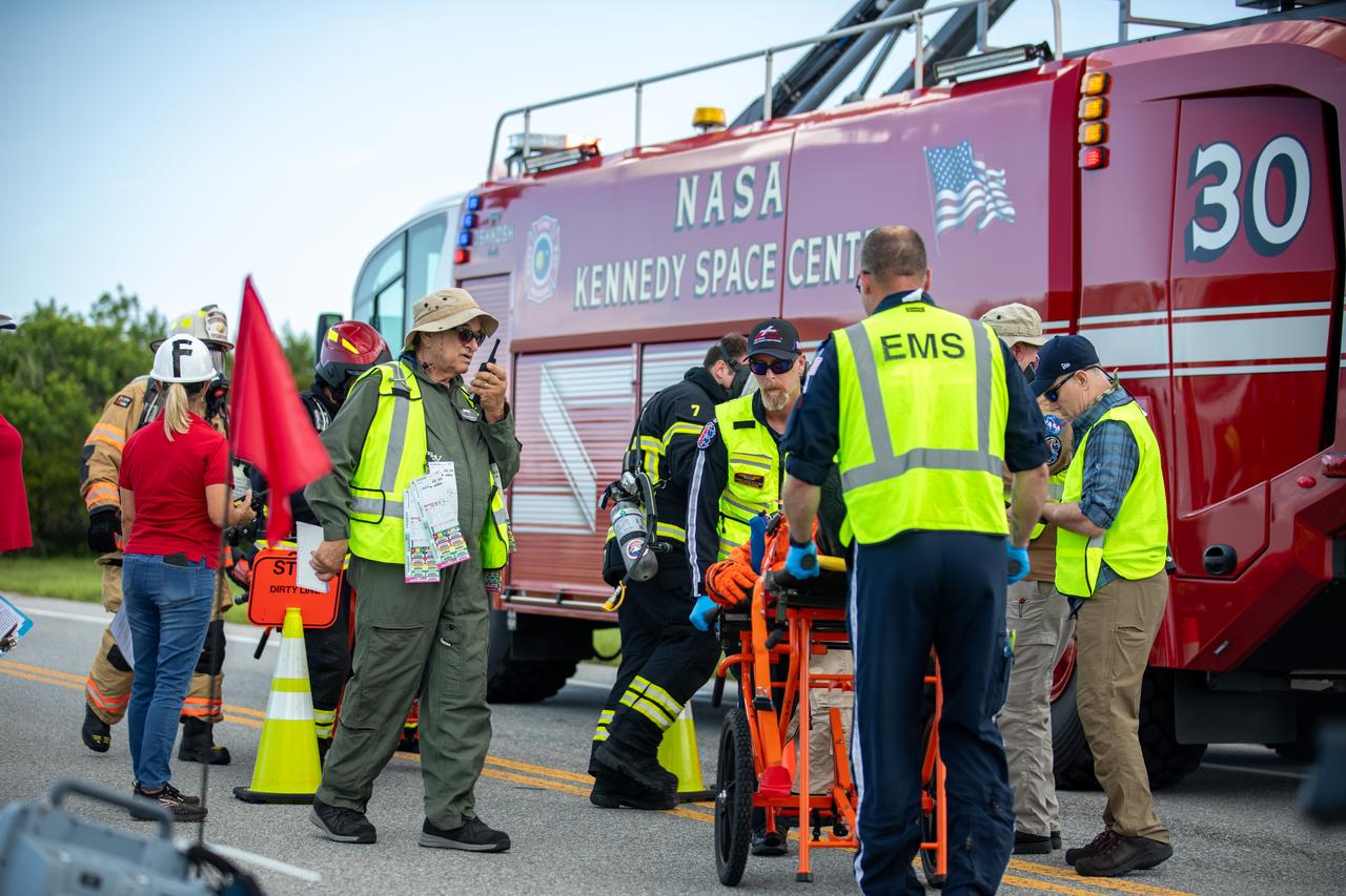 Medical and fire-rescue personnel participate in the Artemis II mission emergency escape or egress verification and validation tests near Launch Complex 39 at NASA's Kennedy Space Center in Florida on Monday, Aug. 12, 2024. During the multi-day tests, members of the closeout crew, pad rescue team, and the Exploration Ground Systems Program practiced the process of getting in and out of the emergency egress baskets then down to the launch pad where they would be transported to emergency transport vehicles and driven to safety. Prior to this test and throughout the course of several months, teams conducted basket release demonstrations to validate the system.