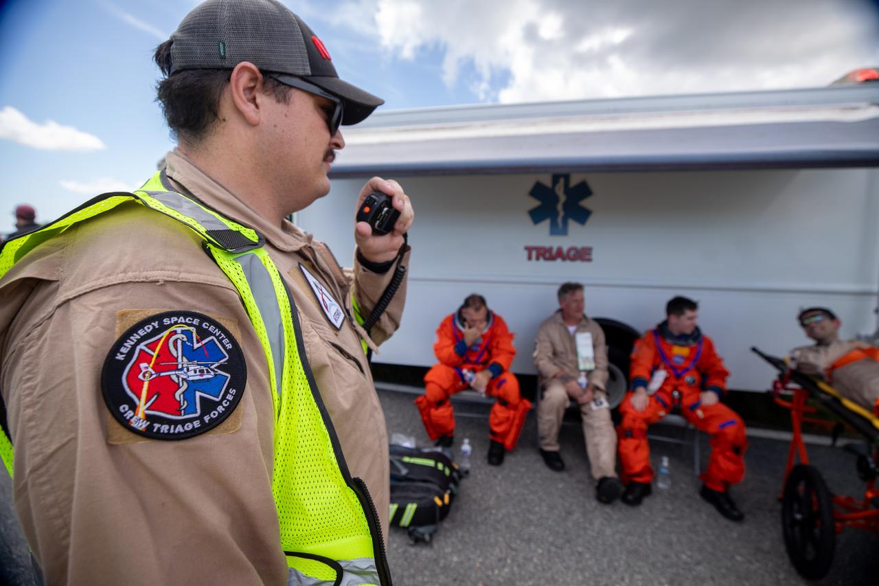 Medical and fire-rescue personnel participate in the Artemis II mission emergency escape or egress verification and validation tests near Launch Complex 39 at NASA's Kennedy Space Center in Florida on Monday, Aug. 12, 2024. During the multi-day tests, members of the closeout crew, pad rescue team, and the Exploration Ground Systems Program practiced the process of getting in and out of the emergency egress baskets then down to the launch pad where they would be transported to emergency transport vehicles and driven to safety. Prior to this test and throughout the course of several months, teams conducted basket release demonstrations to validate the system.