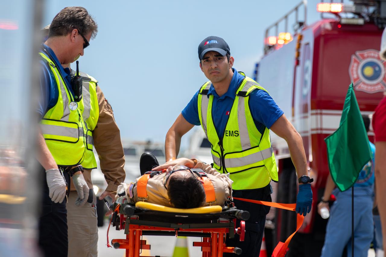 Medical and fire-rescue personnel participate in the Artemis II mission emergency escape or egress verification and validation tests near Launch Complex 39 at NASA's Kennedy Space Center in Florida on Monday, Aug. 12, 2024. During the multi-day tests, members of the closeout crew, pad rescue team, and the Exploration Ground Systems Program practiced the process of getting in and out of the emergency egress baskets then down to the launch pad where they would be transported to emergency transport vehicles and driven to safety. Prior to this test and throughout the course of several months, teams conducted basket release demonstrations to validate the system.