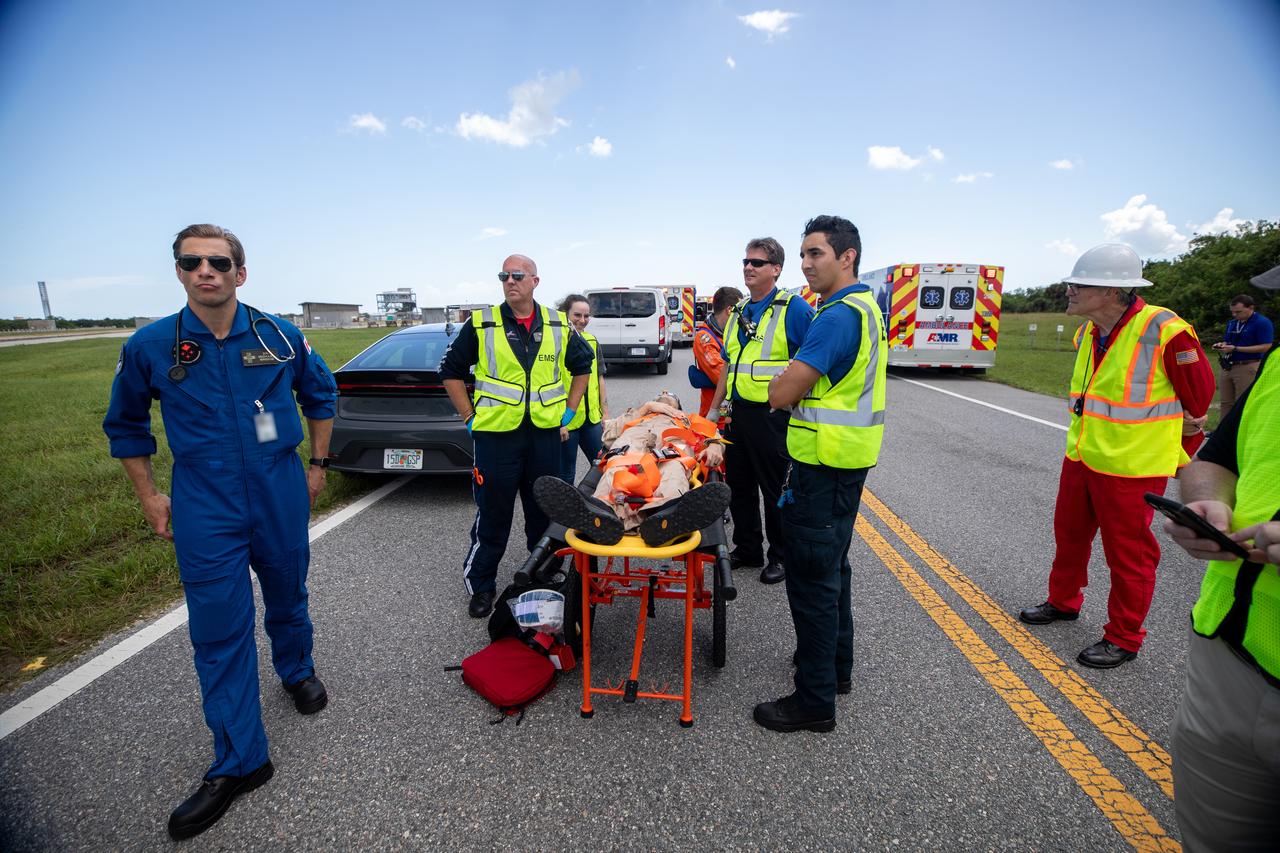 Medical, fire-rescue personnel, and simulated flight crew members participate in the Artemis II mission emergency escape or egress verification and validation tests near Launch Complex 39 at NASA's Kennedy Space Center in Florida on Monday, Aug. 12, 2024. During the multi-day tests, members of the closeout crew, pad rescue team, and the Exploration Ground Systems Program practiced the process of getting in and out of the emergency egress baskets then down to the launch pad where they would be transported to emergency transport vehicles and driven to safety. Prior to this test and throughout the course of several months, teams conducted basket release demonstrations to validate the system.