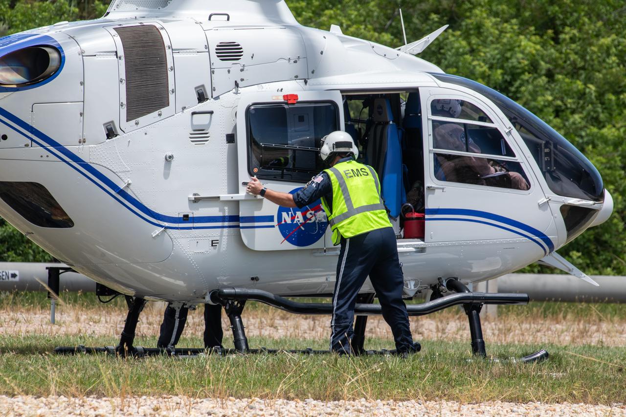Medical and fire-rescue personnel participate in the Artemis II mission emergency escape or egress verification and validation tests near Launch Complex 39 at NASA's Kennedy Space Center in Florida on Monday, Aug. 12, 2024. During the multi-day tests, members of the closeout crew, pad rescue team, and the Exploration Ground Systems Program practiced the process of getting in and out of the emergency egress baskets then down to the launch pad where they would be transported to emergency transport vehicles and driven to safety. Prior to this test and throughout the course of several months, teams conducted basket release demonstrations to validate the system.