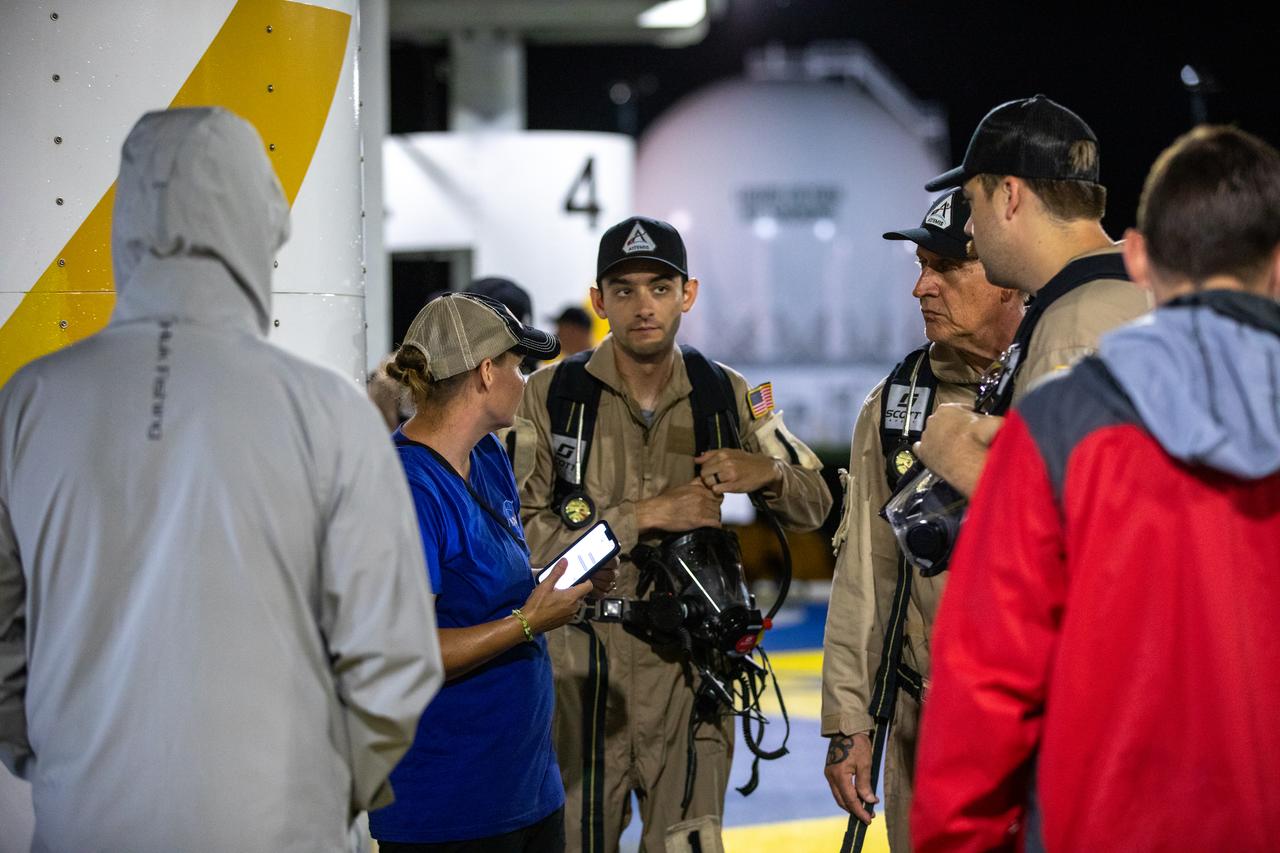 Teams at NASA’s Kennedy Space Center in Florida practice the Artemis mission emergency escape or egress procedures during a series of integrated system verification and validation tests at Launch Pad 39B on Tuesday, Aug. 13, 2024. Members of the closeout crew, pad rescue team and the Exploration Ground Systems Program practiced the process of getting inside and out of the emergency egress baskets. While the crew and other personnel will ride the emergency egress baskets to the terminus area in a real emergency, no one rode the baskets for this test. Instead, teams tested the baskets during separate occasions by using water tanks filled to different levels to replicate simulate the weight of passengers.